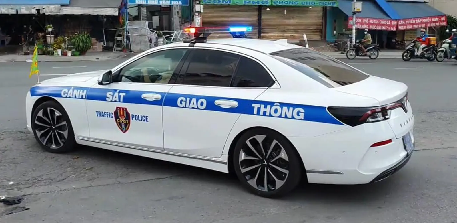 Hvit patruljebil fra trafikkpolitiet, Cảnh sát giao thông, på en gate i Vietnam