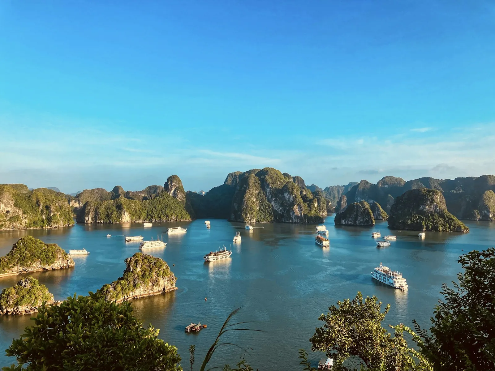 Kalksteinsøyer og turbåter i Ha Long-bukten sett ovenfra